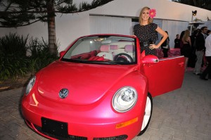Supermodel Heidi Klum stands in for Barbie doll to take delivery of a customized Barbie Dream Car New Beetle.
