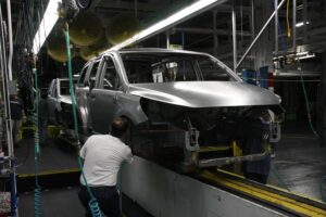 Despite deep cuts in both production capacity and the number of models offered by makers, such as Chrysler -- workers shown here building the Town & Country minivan -- a new study warns that the U.S. market remains dangerously over-crowded.