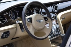 The interior of the 2011 Bentley Mulsanne continues to be swathed in leather and hand-finished wood, but the steering wheel-mounted paddle shifters hint at the new technology that will debut on the big saloon car.