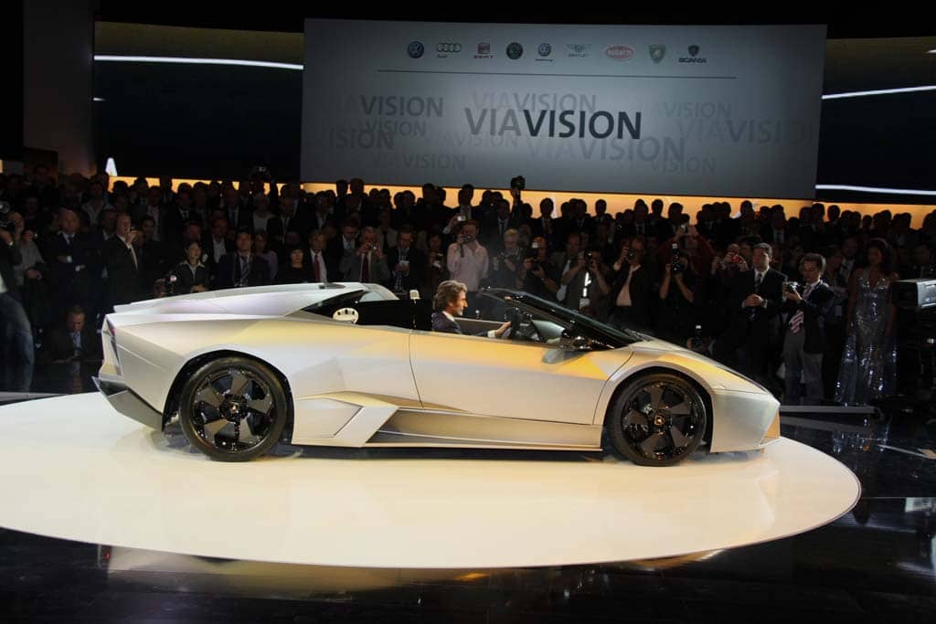 CEO Stephan Winklemann drives onto the stage in a 2010 Lamborghini Reventon