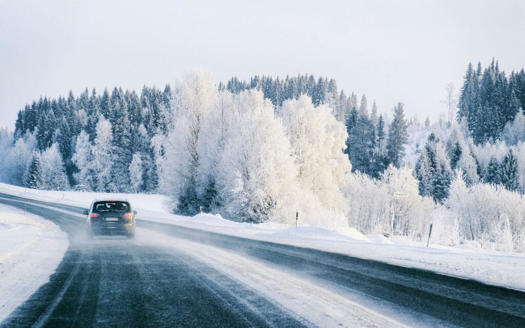 Car at a road a snowy winter Lapland reflex