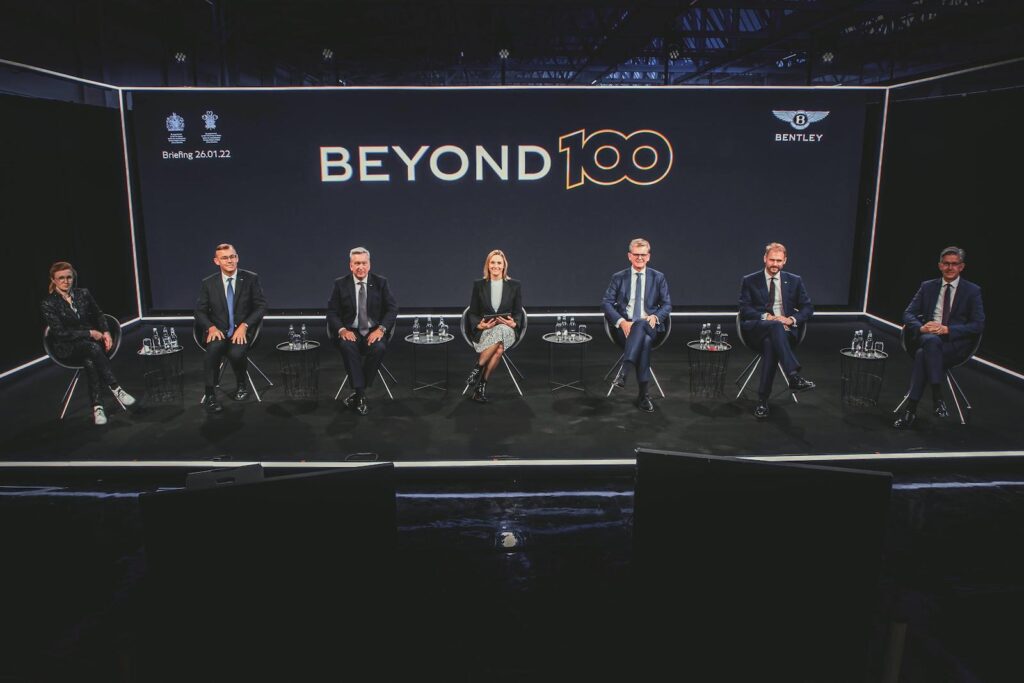 Beyond100 update executives on stage