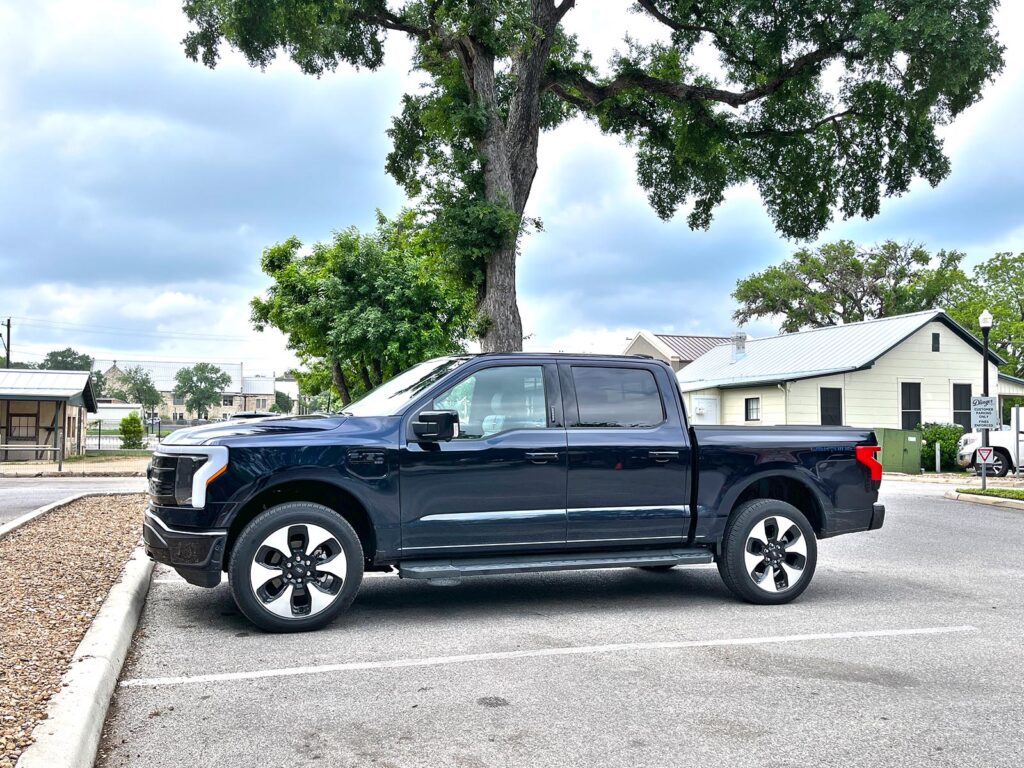 2022 Ford F-150 Lightning Platinum - parked by tree