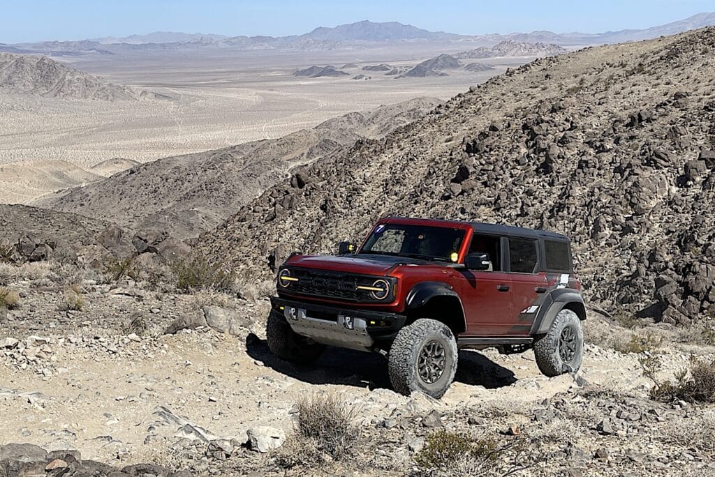 2022 Ford Bronco Raptor maroon going up trail