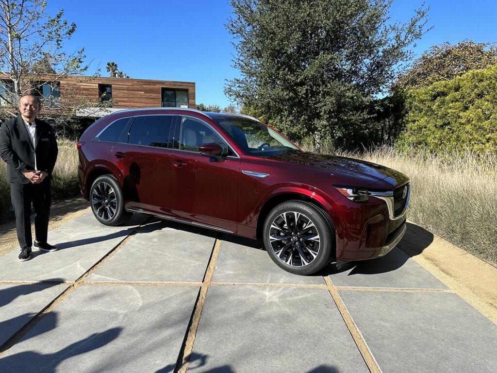 Mazda CX-90 - front 3-4 with house and design chief