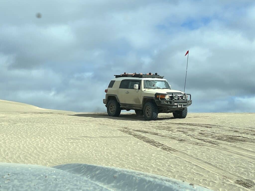 Toyota FJ6 atop dune on Firestone Destinations